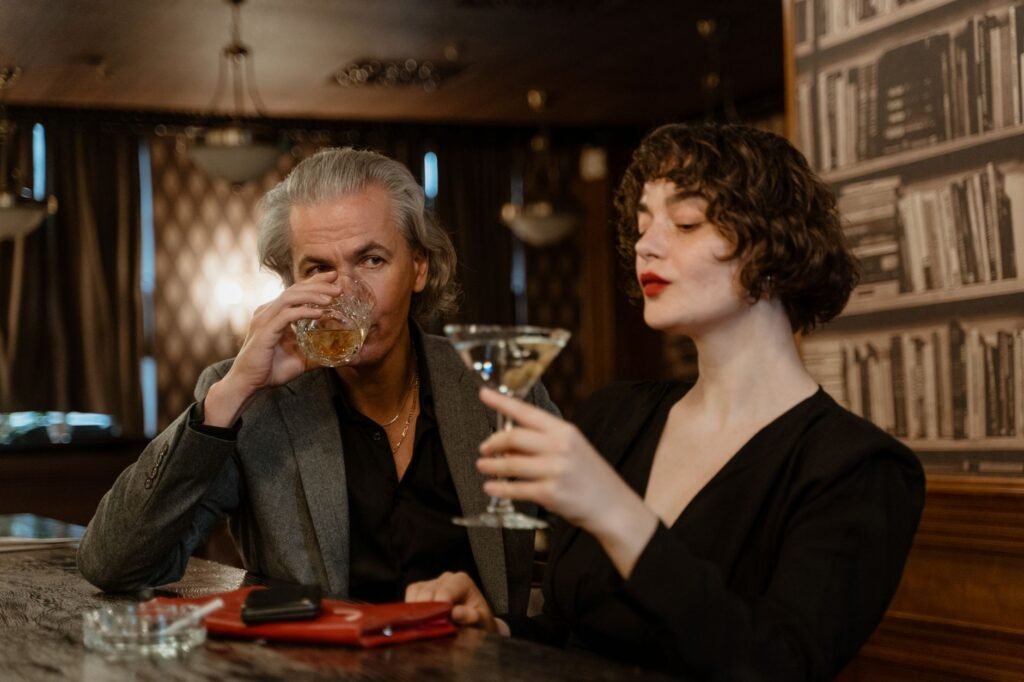 Two adults sharing an evening drink at an outdoor table