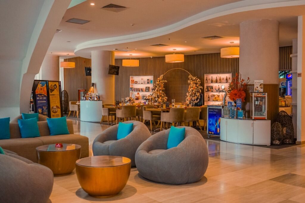 A quietly lit hotel lounge in the evening with adults seated discreetly in the background