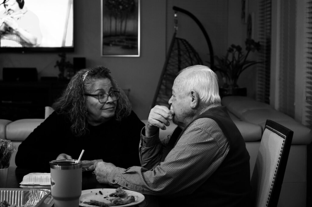A couple in quiet conversation at a softly lit table