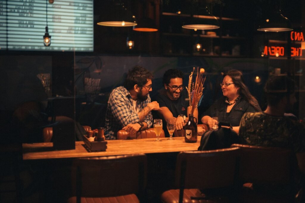 Two adults in smart-casual clothing having a calm conversation at an evening table