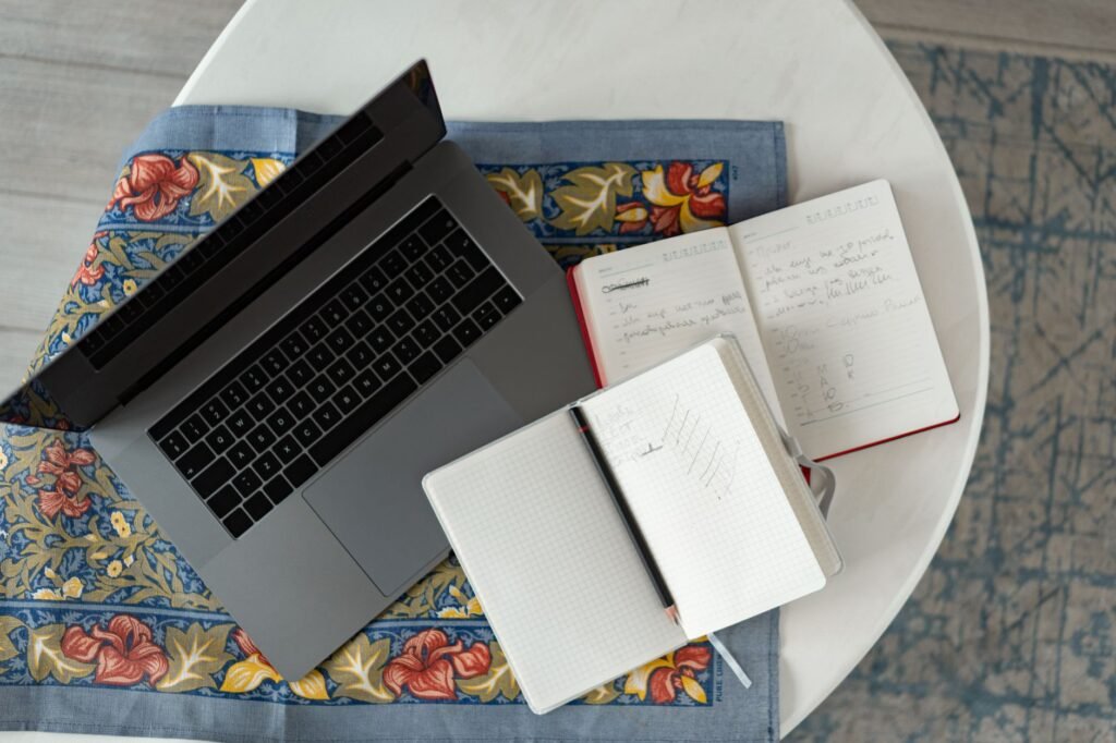 Notebook and smartphone on a hotel desk used for planning a discreet meeting