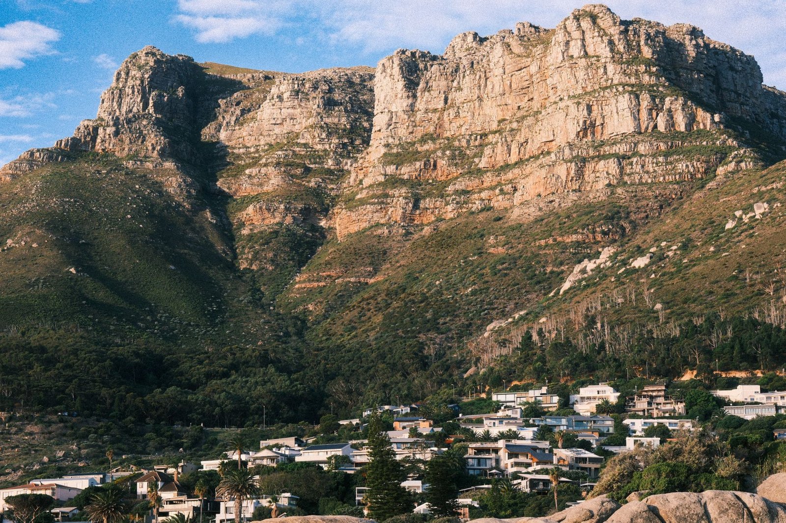 Quiet residential street in Clifton, Cape Town, with white houses and ocean views