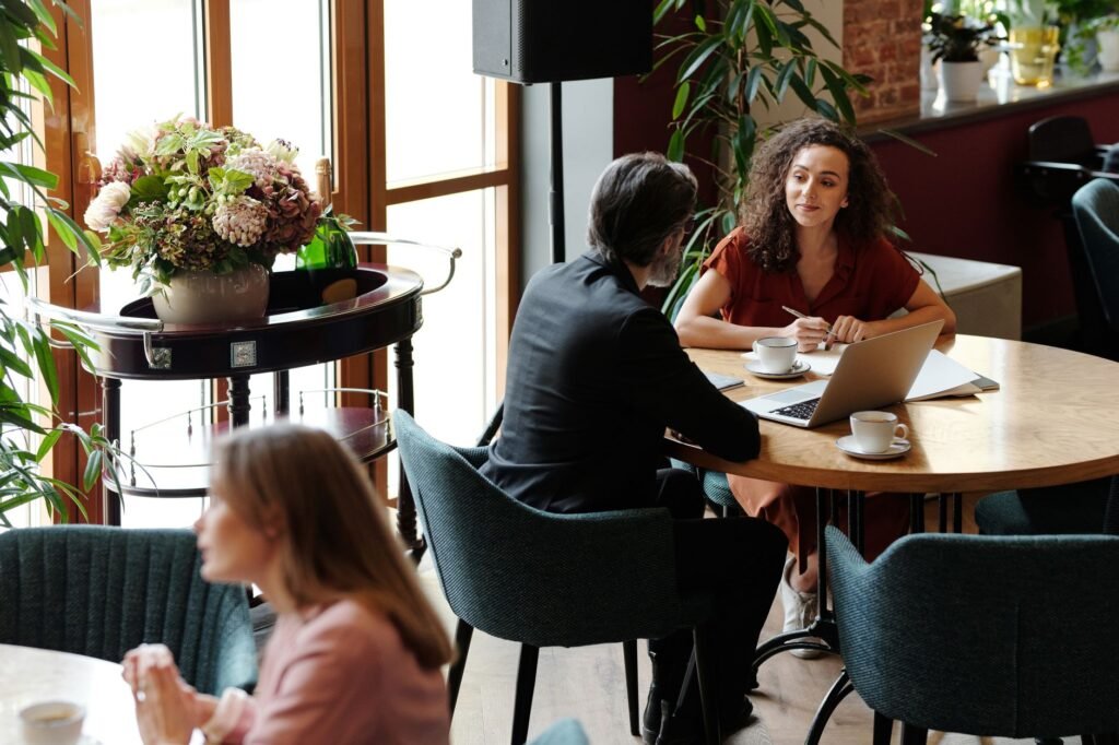 Two people in quiet conversation at a cafe table
