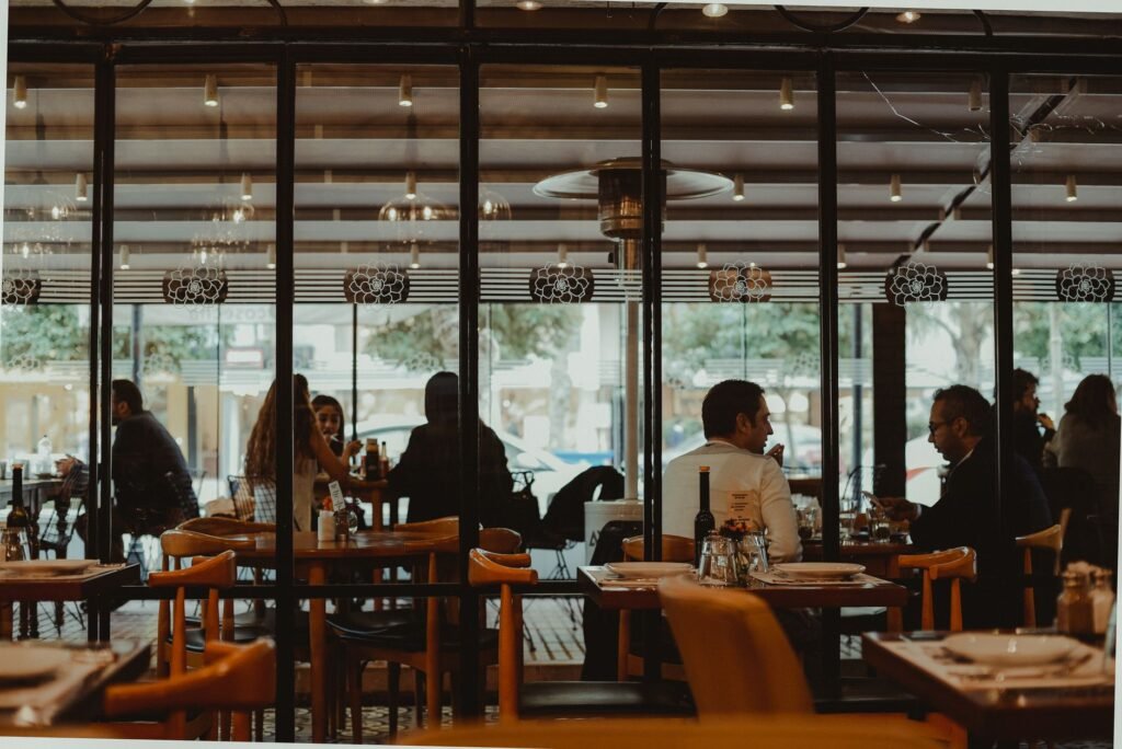 Two people in respectful conversation at a restaurant table