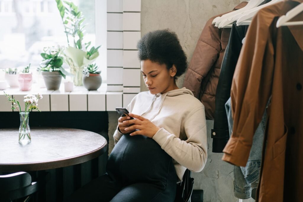 Person reading a profile on a smartphone at a café table