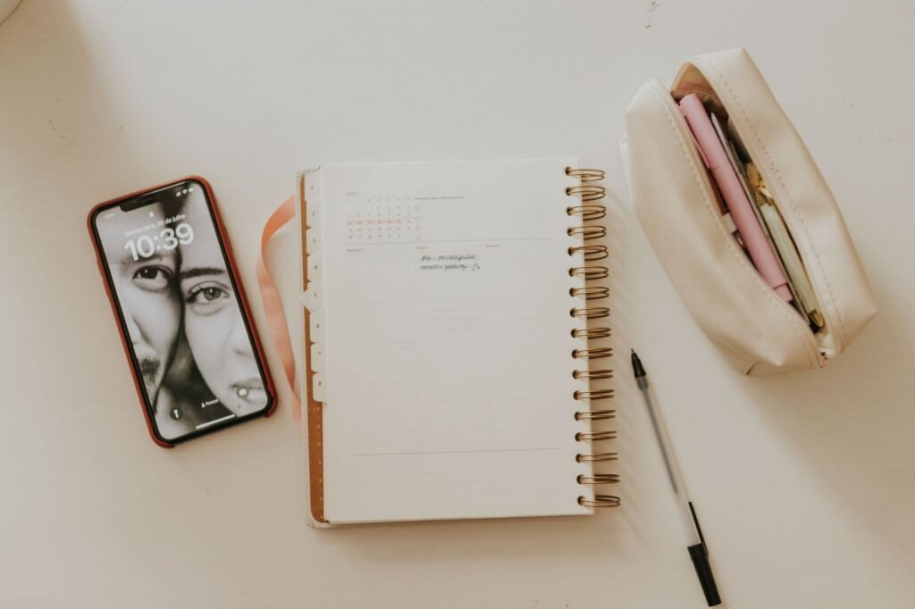 Notebook and smartphone on a desk with soft daylight