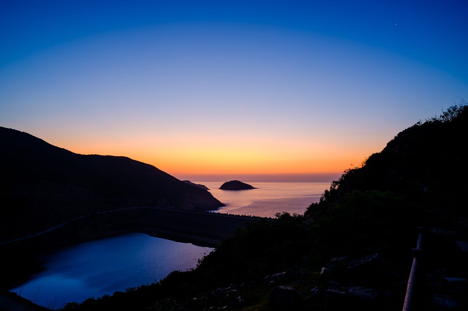 Evening view over Hartbeespoort Dam with the Magaliesberg mountains in the background