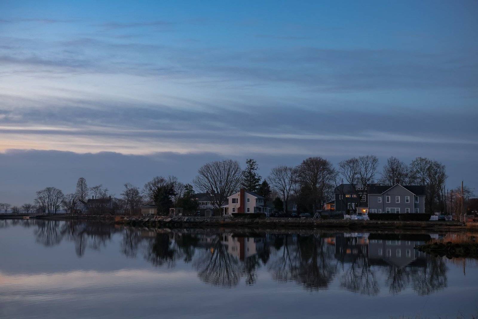 Coastal town at golden hour where a river mouth meets the sea