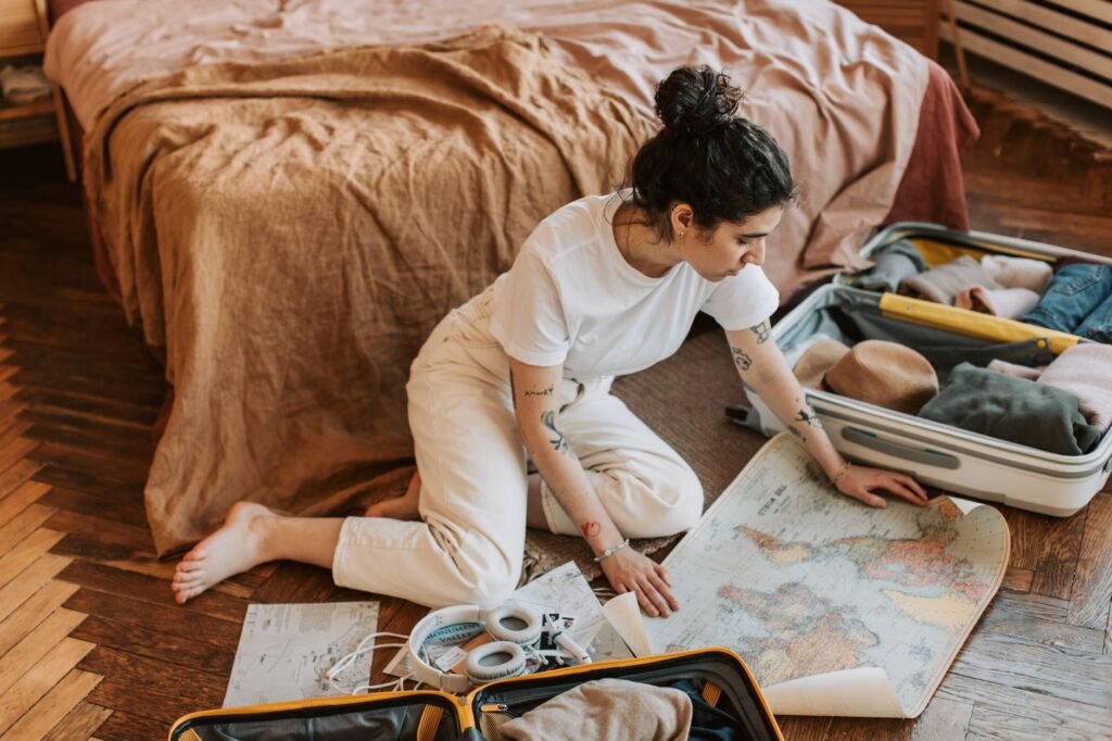 Person planning a trip with a notebook and smartphone in a hotel room