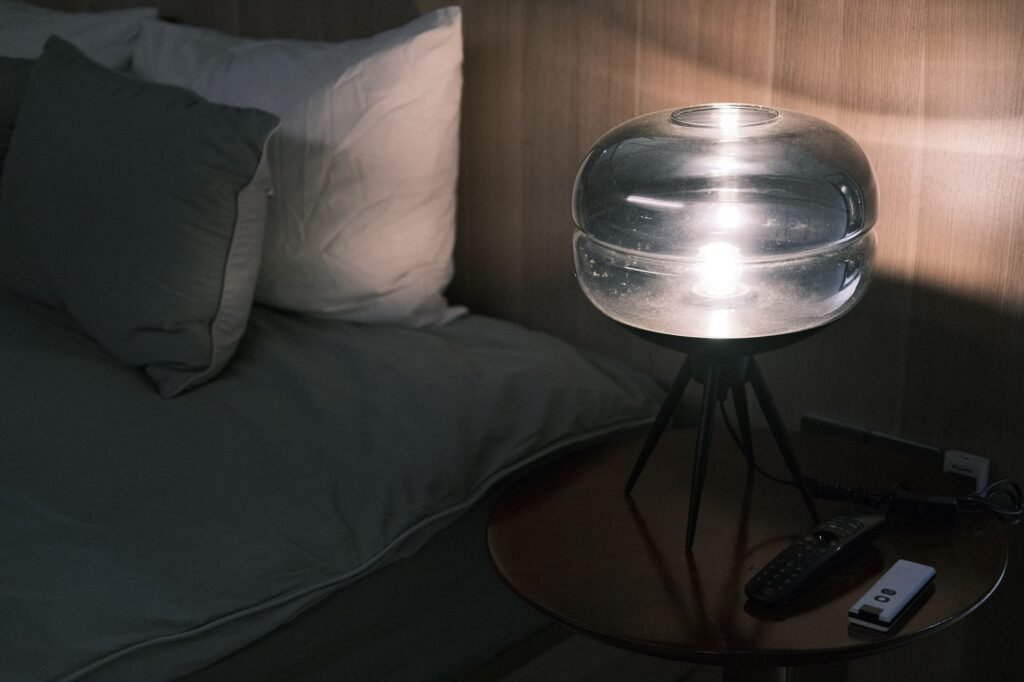 Smartphone, notebook and map arranged on a guesthouse bedside table